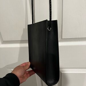 Black Small Purse with twist braided strap. Closes with one button.